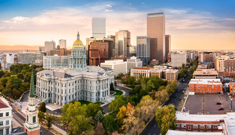 Denver Capitol Building and downtown Denver skyline during the day.