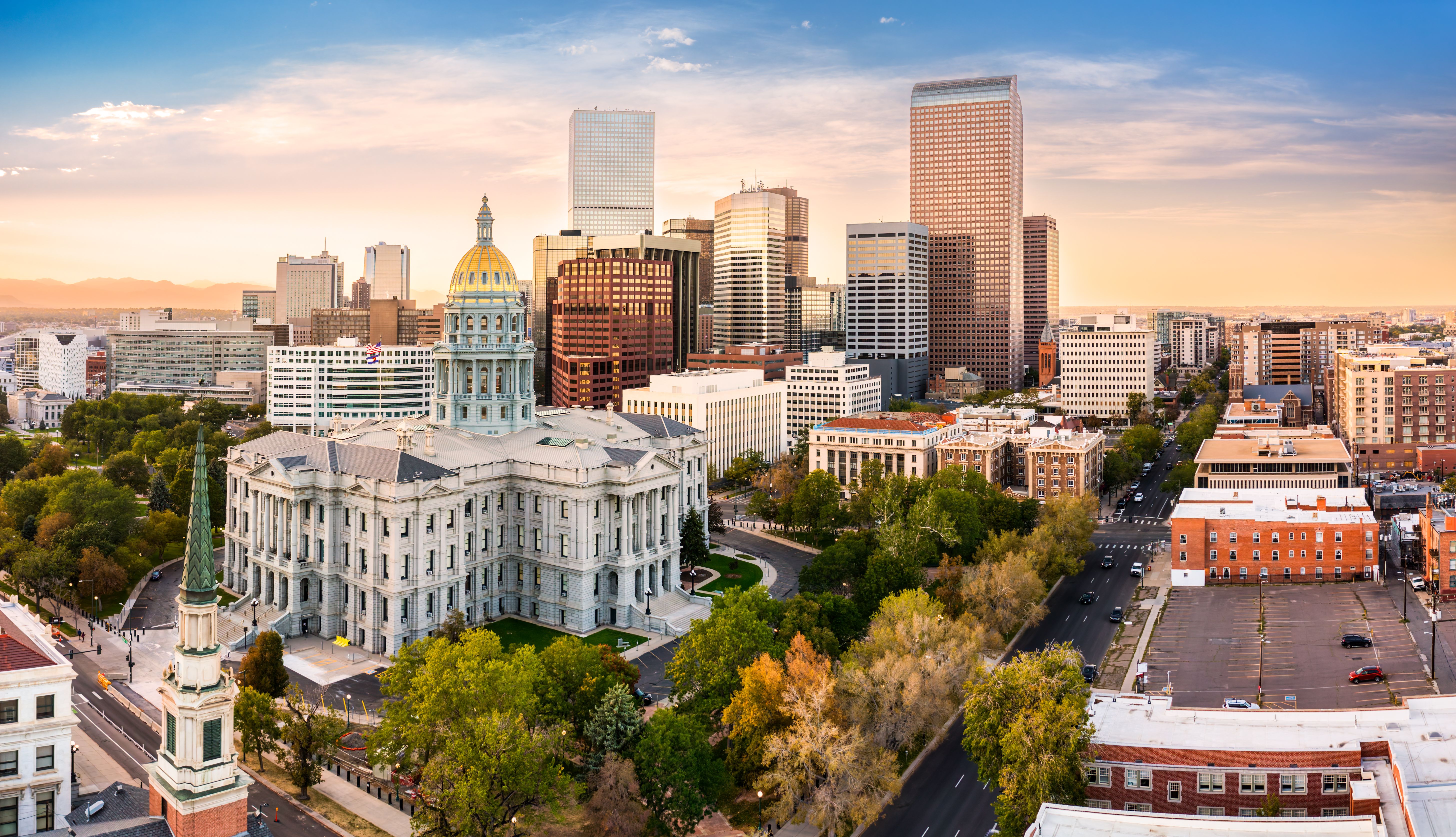 Denver Capitol Building and downtown Denver skyline during the day.